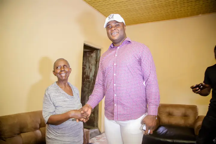 Shaking hands with an elderly woman during a home visit