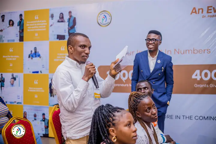 A participant asking a question beside the impact wall