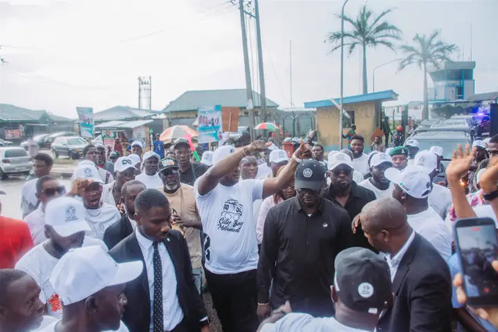 Dr Paddy Iyamu walking with supporters