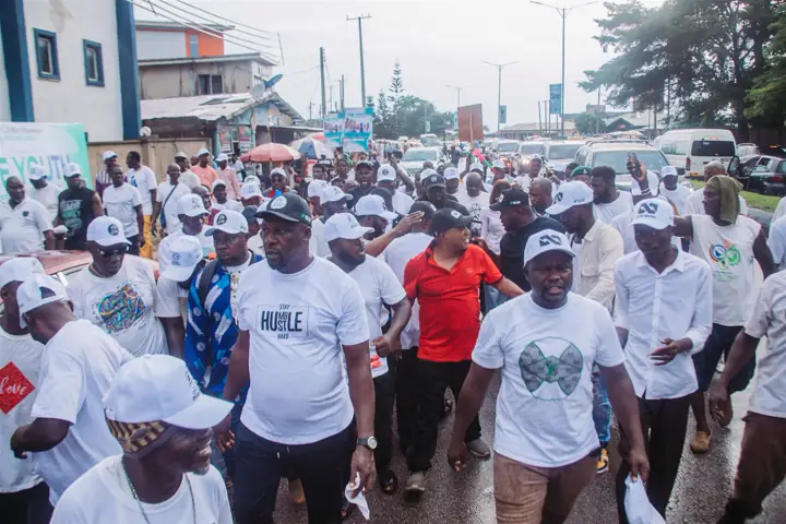 Dr Paddy Iyamu at the head of a street procession